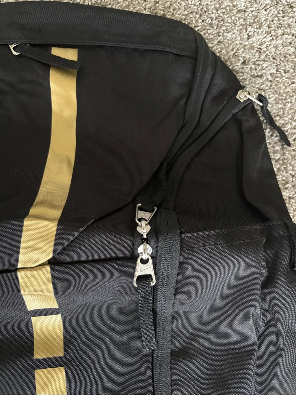 Nike Black Backpack with Gold Stripe and White Swoosh